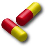 薬のイメージ画像（赤と黄色のカプセル）