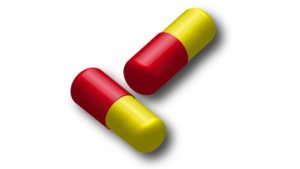 薬のイメージ画像（赤と黄色のカプセル）
